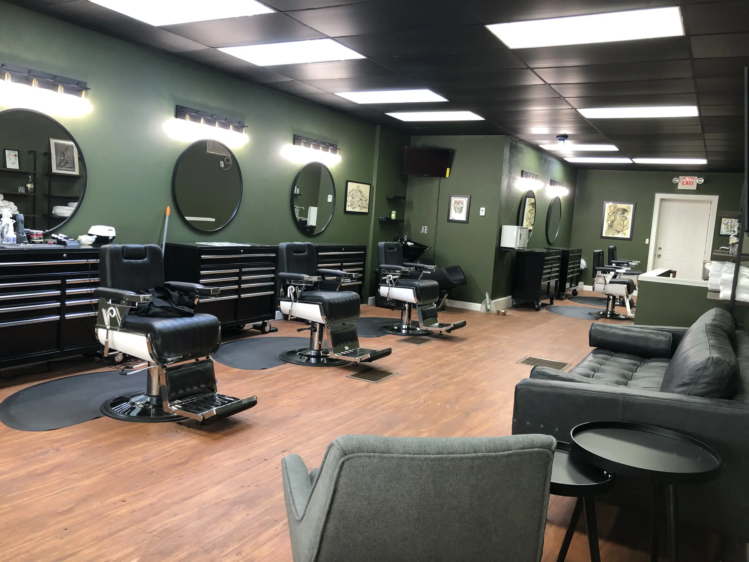Inside Southside Barber Lounge — green walls, round mirrors, barbers at work